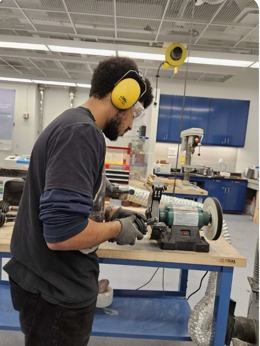A CCNY Racing member machining a part in the shop