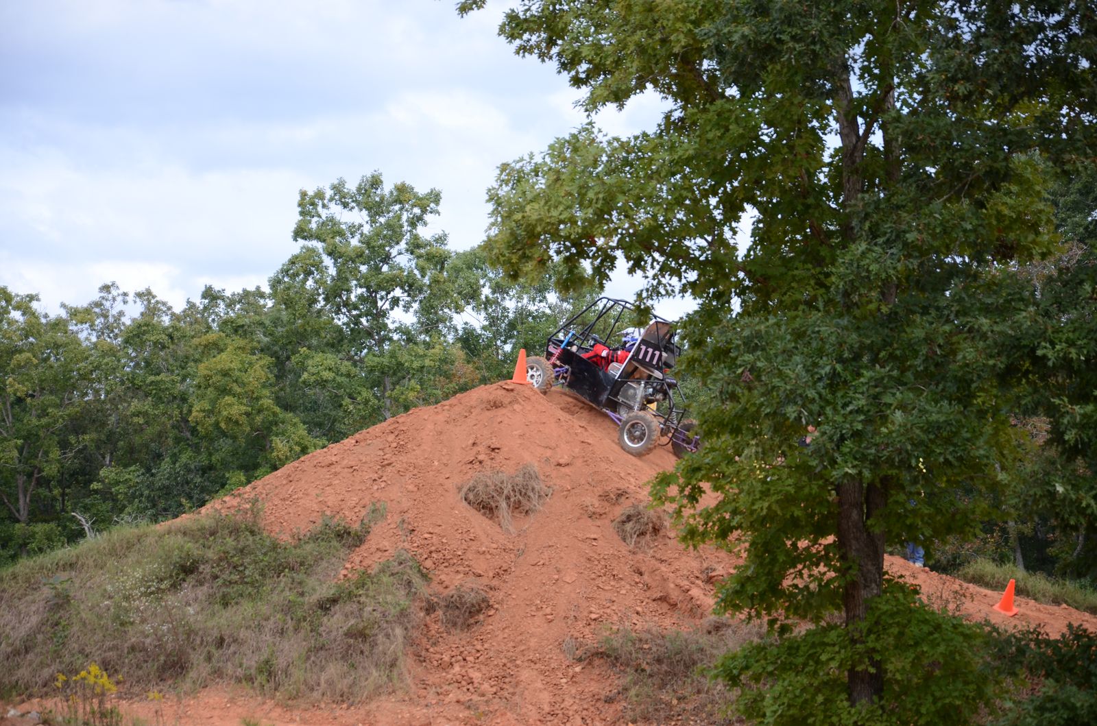 Car climbing a steep dirt hill